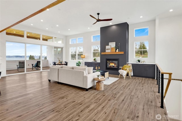 8721 Semiahmoo Dr, Blaine, WA 98230 - living area featuring light wood-style floors, a high ceiling, recessed lighting, a large fireplace, and a ceiling fan