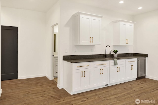 8721 Semiahmoo Dr, Blaine, WA 98230 - kitchen with wood finished floors, dark countertops, a sink, and wine cooler