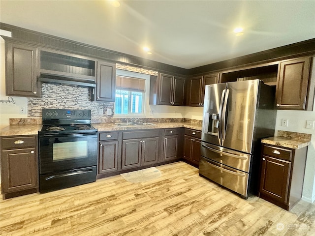 kitchen featuring stainless steel refrigerator with ice dispenser, dark brown cabinetry, sink, electric range, and light hardwood / wood-style flooring