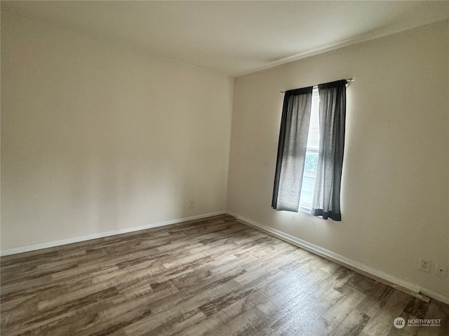 unfurnished room featuring hardwood / wood-style flooring