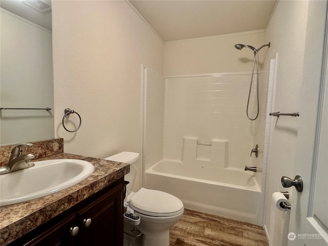 full bathroom featuring hardwood / wood-style floors, vanity, washtub / shower combination, crown molding, and toilet