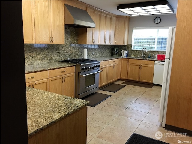 kitchen with high end range, backsplash, stone counters, and wall chimney range hood