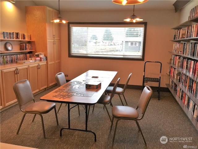 dining area with dark carpet