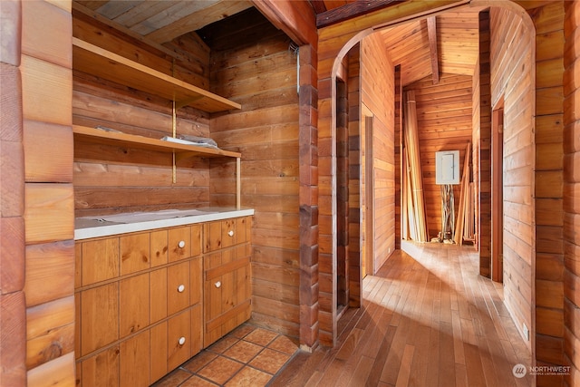 interior space with wood ceiling, wood walls, and light hardwood / wood-style floors