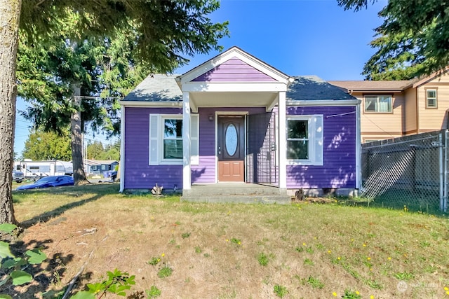 bungalow-style home featuring a front lawn