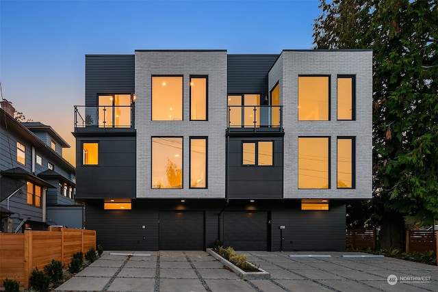 exterior space featuring a balcony and a garage