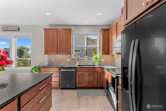 kitchen featuring backsplash, stainless steel appliances, plenty of natural light, and sink