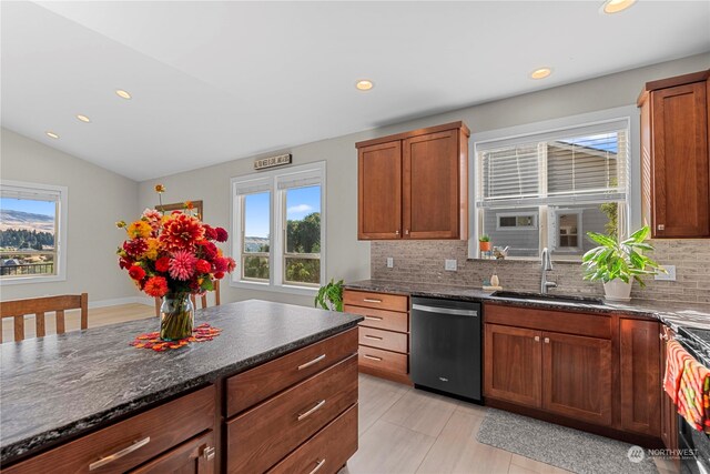 kitchen featuring dishwasher, decorative backsplash, lofted ceiling, and sink