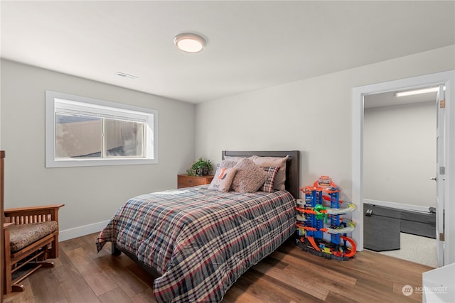 bedroom with hardwood / wood-style flooring