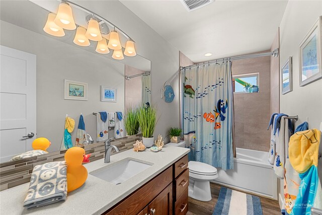 full bathroom featuring shower / tub combo, backsplash, vanity, hardwood / wood-style floors, and toilet