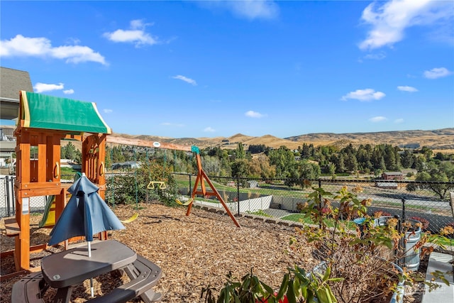 view of playground featuring a mountain view