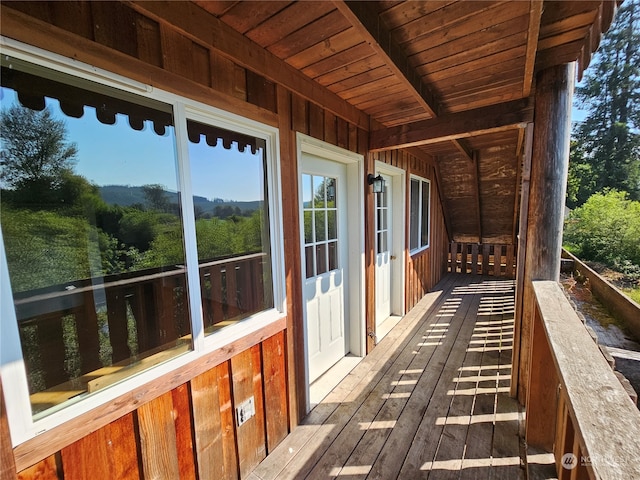 exterior space featuring beam ceiling and wooden ceiling