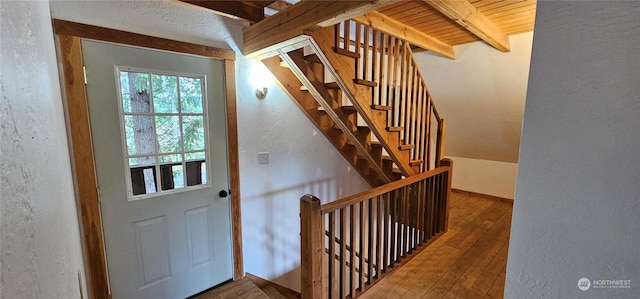 doorway with hardwood / wood-style flooring, beam ceiling, and wood ceiling