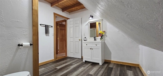 bathroom featuring toilet, vaulted ceiling with beams, wood ceiling, hardwood / wood-style flooring, and vanity