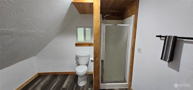 bathroom with hardwood / wood-style floors, toilet, and an enclosed shower