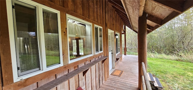 wooden terrace featuring a lawn