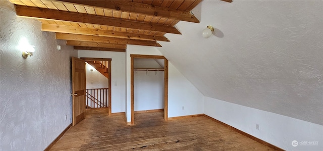 additional living space featuring hardwood / wood-style flooring, wood ceiling, and lofted ceiling with beams