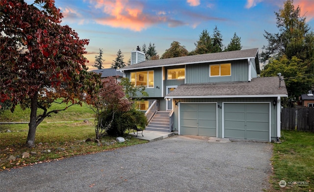 view of front facade with a lawn and a garage