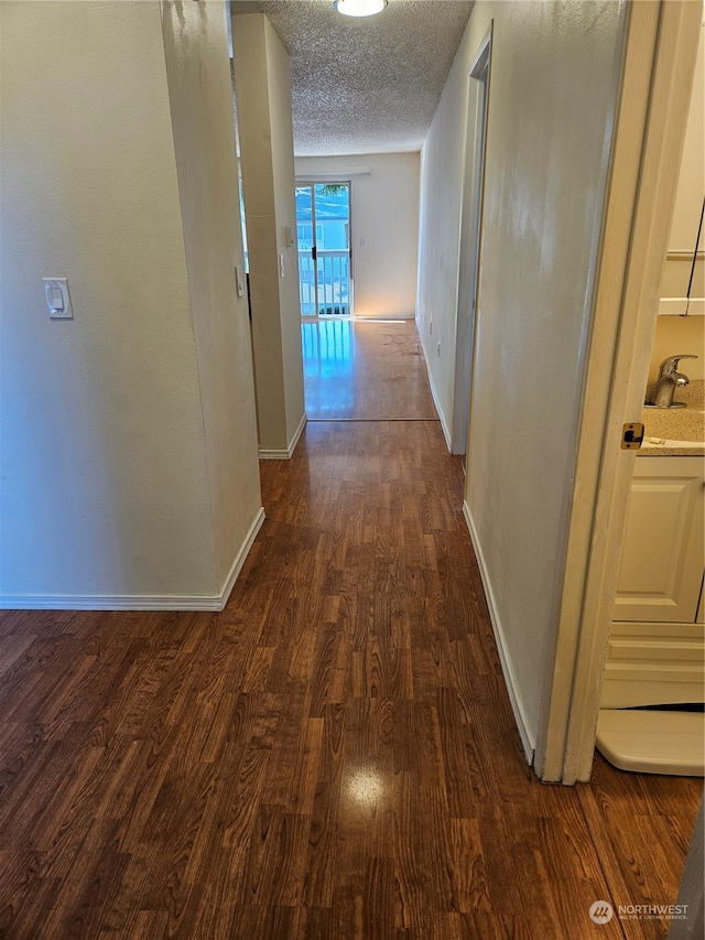 31003 14th Ave S Unit E-10, Federal Way, WA 98003 - hallway with a textured ceiling and dark hardwood / wood-style flooring