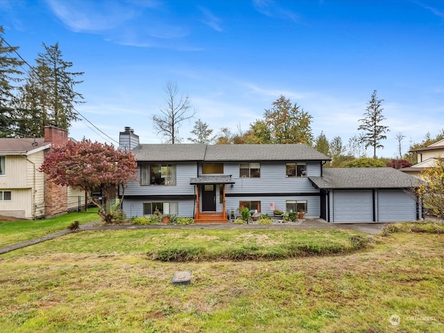 split foyer home with a garage and a front lawn