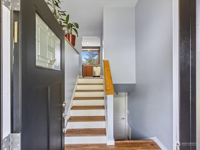 stairs with hardwood / wood-style flooring