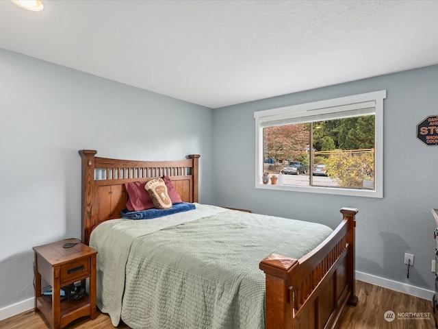 bedroom with hardwood / wood-style flooring