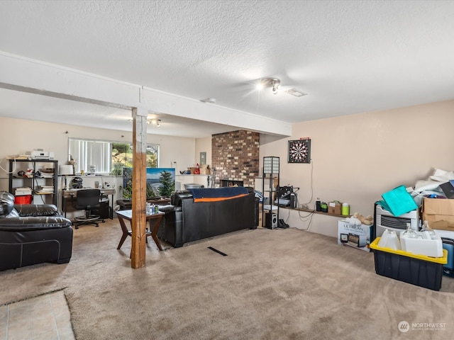 carpeted living room featuring a fireplace and a textured ceiling