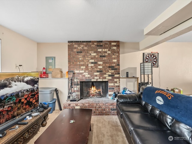 living room featuring a brick fireplace