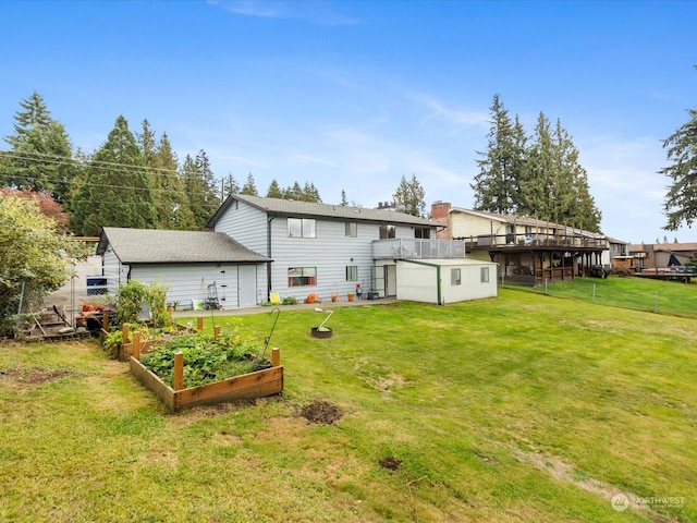 rear view of house featuring a yard