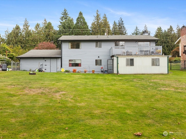 back of house featuring a wooden deck and a yard