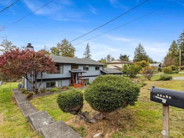 raised ranch with a front lawn