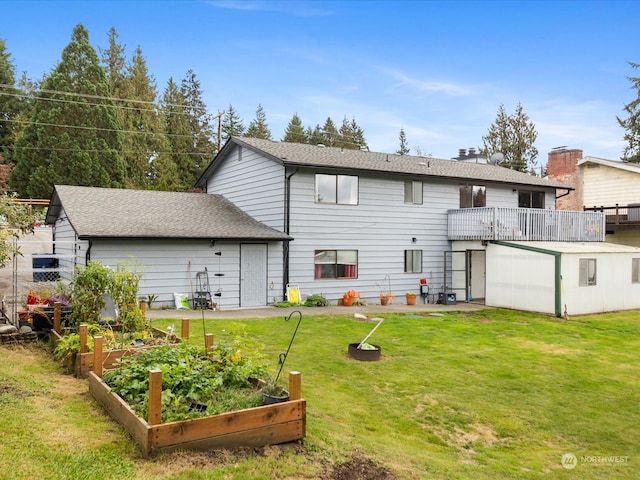 back of house with a wooden deck and a lawn