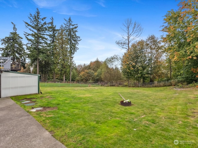 view of yard with a fire pit