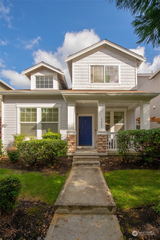 view of front of house featuring a porch and a front yard