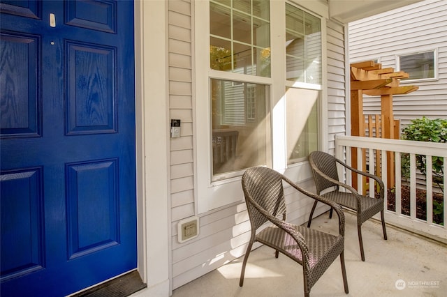 view of exterior entry featuring covered porch