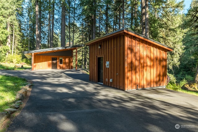 garage featuring wood walls and a carport