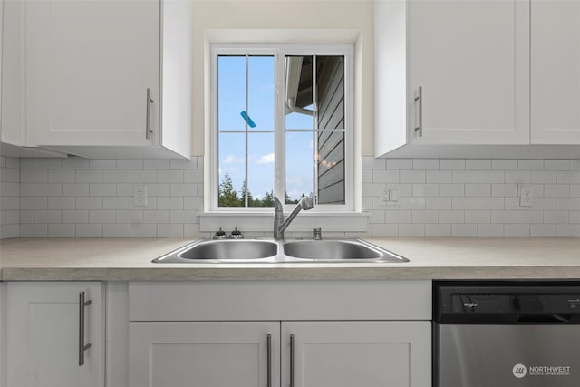 kitchen featuring a wealth of natural light, white cabinets, sink, and stainless steel dishwasher