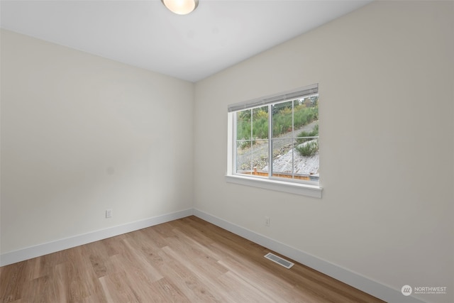 spare room featuring light wood-type flooring