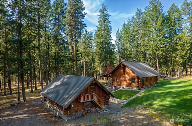 view of outbuilding with a wooded view and stairs