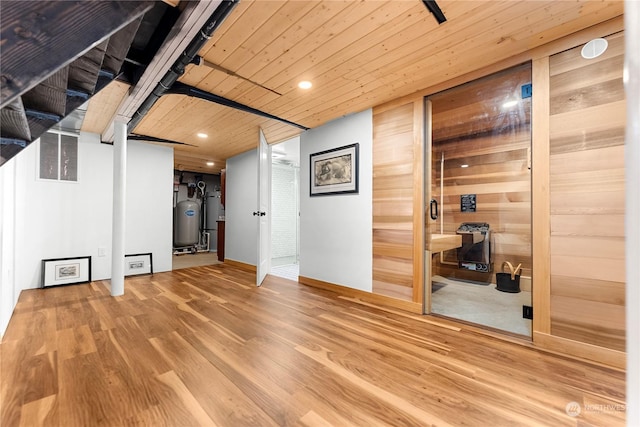 interior space featuring wood ceiling, wood walls, wood finished floors, baseboards, and recessed lighting