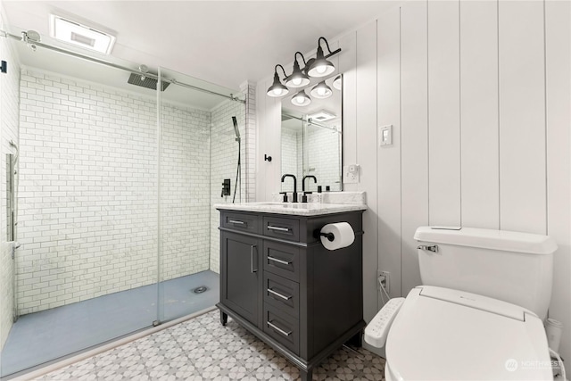 bathroom featuring vanity, tile patterned floors, a stall shower, and toilet