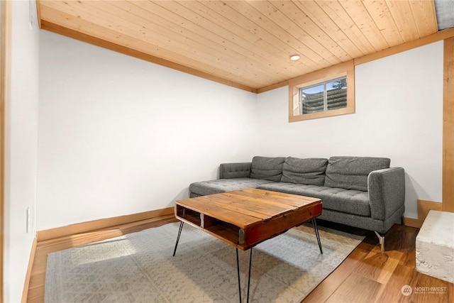 living room featuring wood ceiling, baseboards, and wood finished floors