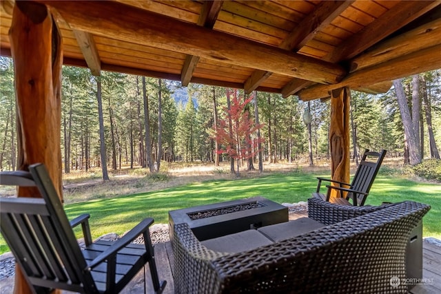 view of patio featuring a forest view and a fire pit