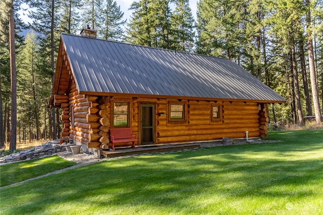 rear view of house featuring a porch and a yard