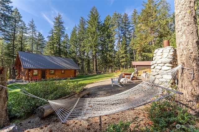 view of yard featuring an outdoor fire pit