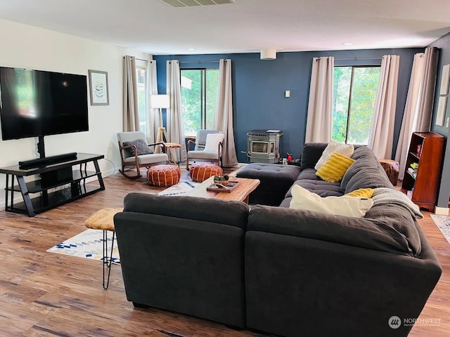 living room featuring hardwood / wood-style floors and a wood stove