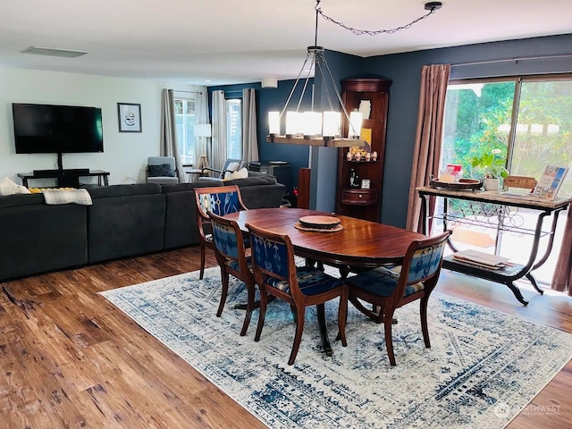 dining room featuring hardwood / wood-style floors and a chandelier