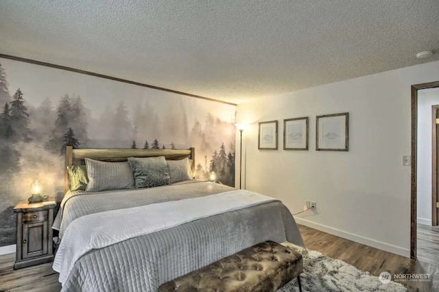 bedroom featuring hardwood / wood-style flooring and a textured ceiling