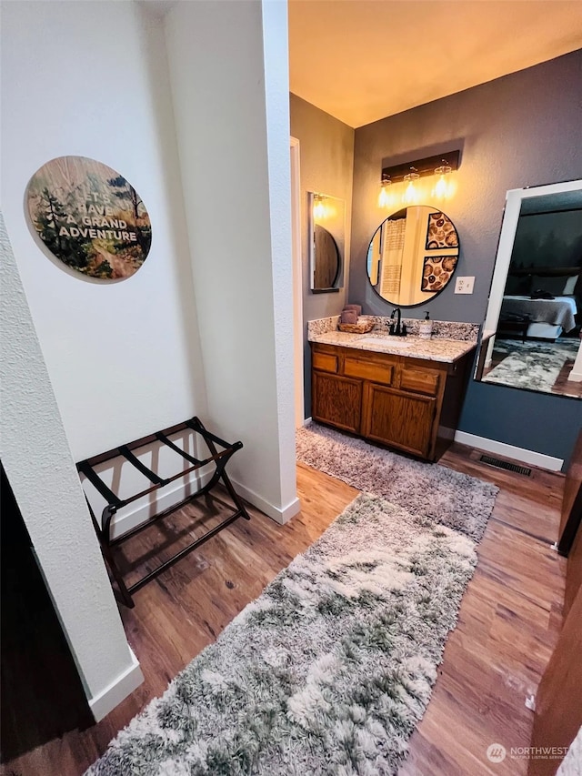 bathroom featuring vanity and hardwood / wood-style floors