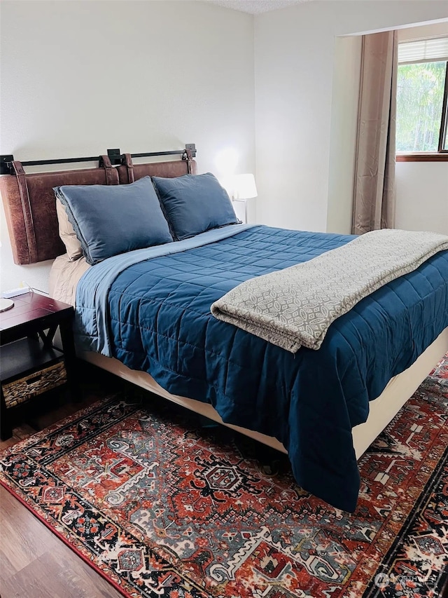 bedroom with dark wood-type flooring